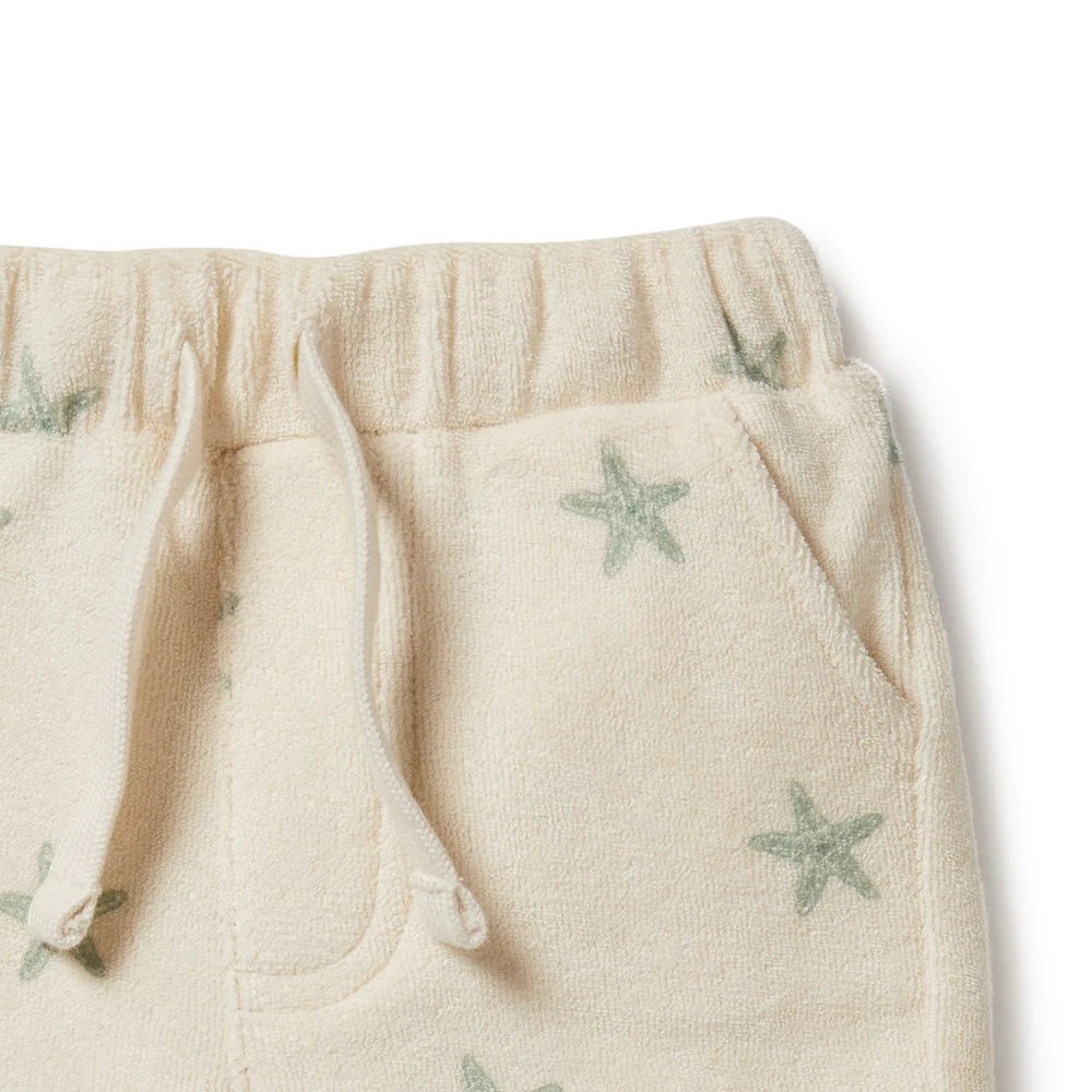 This Wilson and Frenchy terry towelling short delivers a perfect fit for summer fun. Crafted from organic fabric, it features a functional tie front, this short provides your little one with unrestricted comfort and movement all day long. Enjoy carefree playtime in style and comfort. Ships to Canada & US Duty Free.